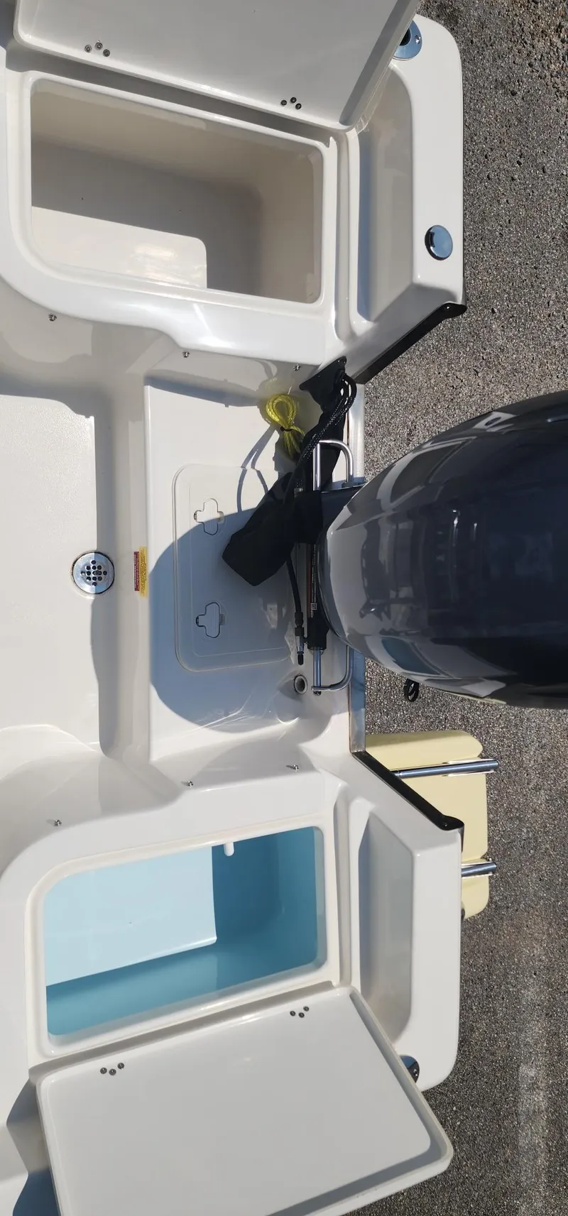 Slide: The Image of 2024 Key West 1720CC boat with open storage compartments and motor, viewed from above. - 18