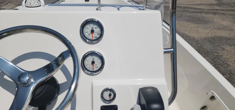 Slide: The Image of 2024 Key West 1720CC boat dashboard with steering wheel and gauges. - 24