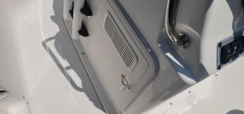 Slide: The Image of 2024 Key West 1720CC boat interior detail with storage compartment and handle. - 33