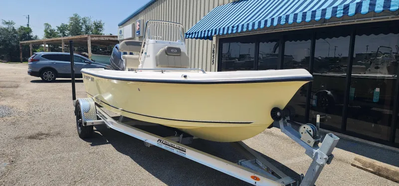 Slide: The Image of 2024 Key West 1720CC boat on trailer outside a building with blue awning. - 5
