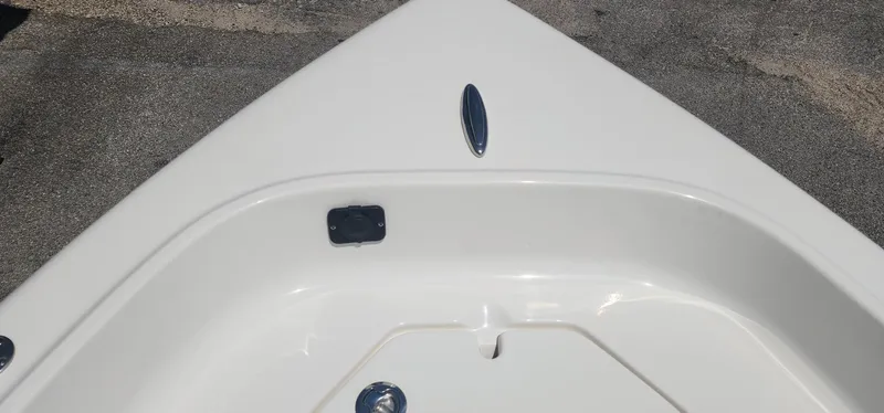 Slide: The Image of 2024 Key West 1720CC boat bow detail, white finish, on pavement background. - 9