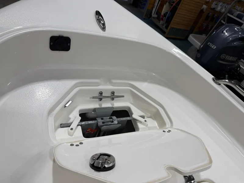 Slide: The Image of 2025 Key West 1720CC boat anchor compartment with Yamaha engine in background. - 11
