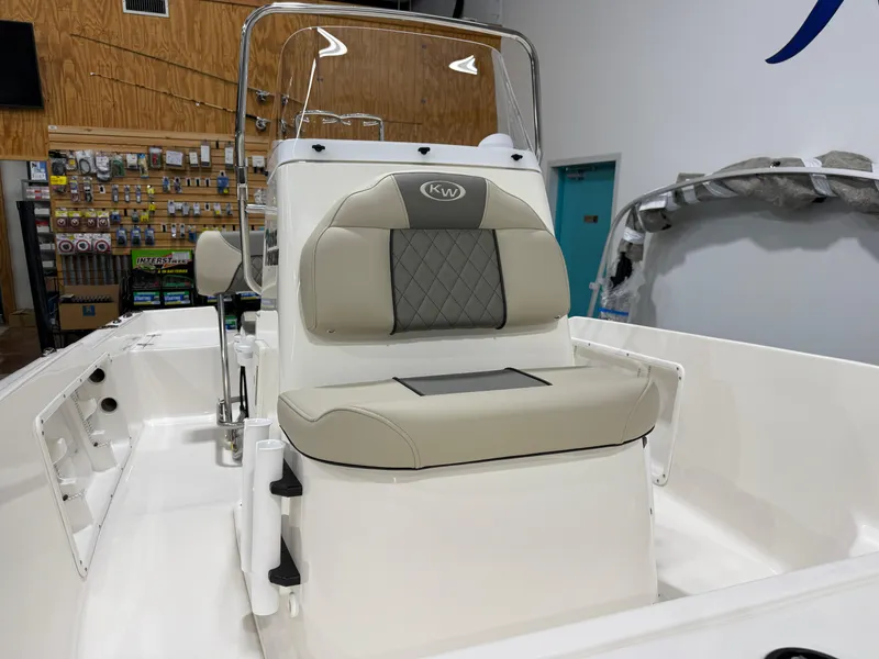 Slide: The Image of 2025 Key West 1720CC boat interior with beige seating in showroom. - 12