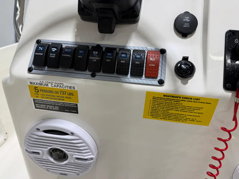 Slide: The Image of Control panel of 2025 Key West 1720CC boat with capacity and safety checklist. - 16