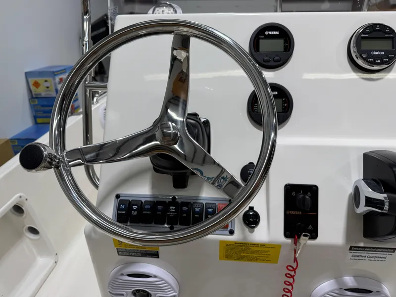 Slide: The Image of 2025 Key West 1720CC boat dashboard with steering wheel and control panel. - 19
