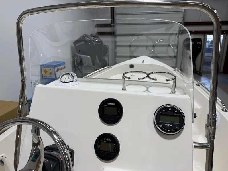 Slide: The Image of 2025 Key West 1720CC boat dashboard with gauges and steering wheel. - 20