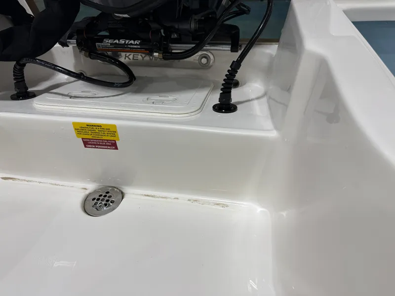 Slide: The Image of 2025 Key West 1720CC boat interior with Seastar hydraulic steering system. - 23