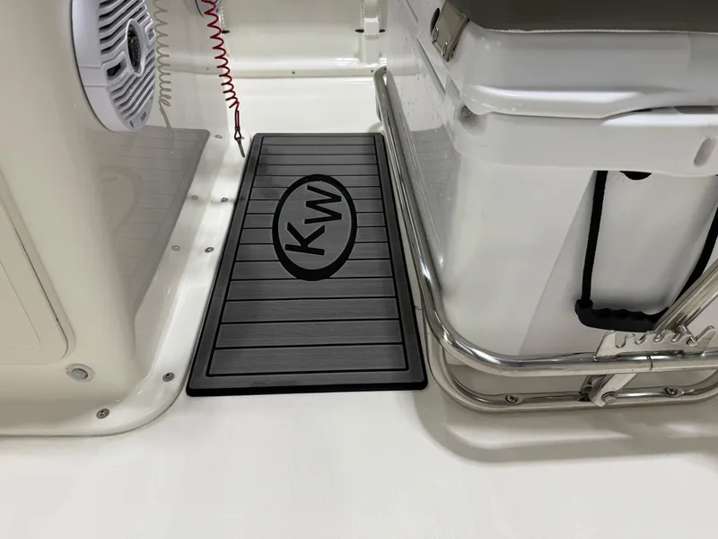 Slide: The Image of Key West 1720CC boat interior, featuring KW logo mat and cooler, 2025 model. - 24