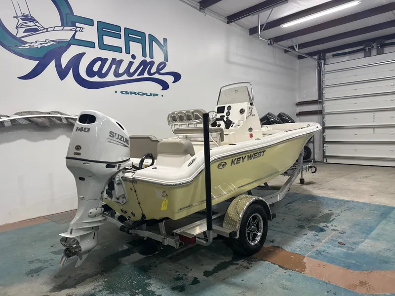 Slide: The Image of 2024 Key West 189FS boat with Suzuki engine in a garage. - 10