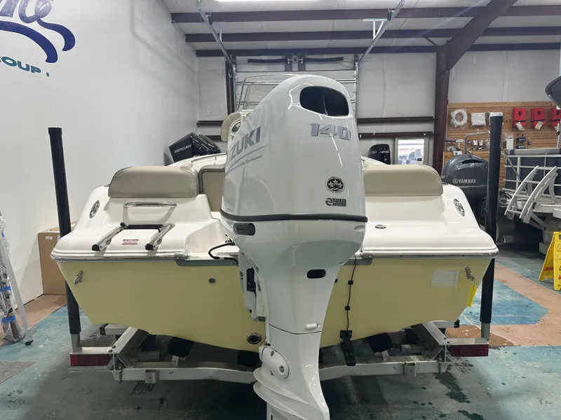 Slide: The Image of 2024 Key West 189FS boat with Suzuki 140 outboard motor in showroom. - 11