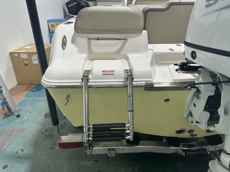 Slide: The Image of 2024 Key West 189FS boat with ladder and outboard motor in a garage setting. - 12