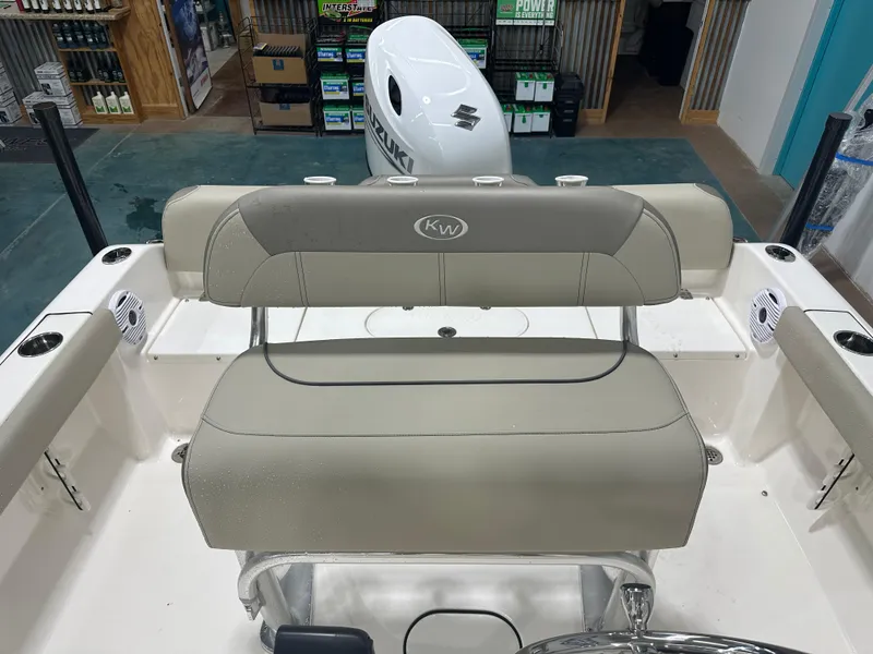 Slide: The Image of 2024 Key West 189FS boat interior with seating and Suzuki engine in showroom. - 14