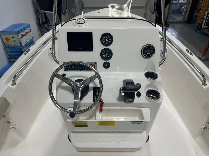 Slide: The Image of 2024 Key West 189FS boat dashboard with steering wheel and gauges. - 15