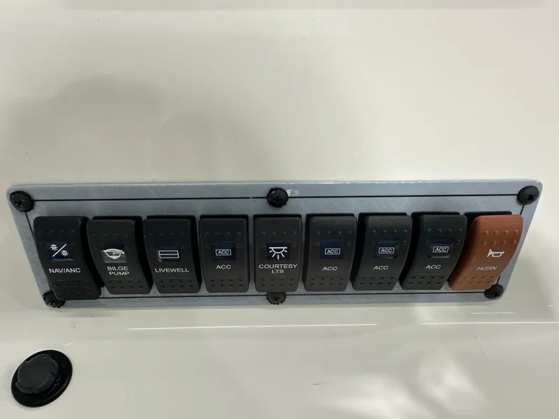 Slide: The Image of Control panel of 2024 Key West 189FS boat with various switches. - 17