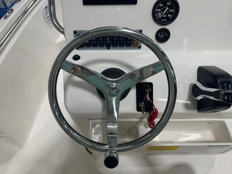 Slide: The Image of 2024 Key West 189FS boat steering wheel and controls, featuring gauges and ignition keys. - 20