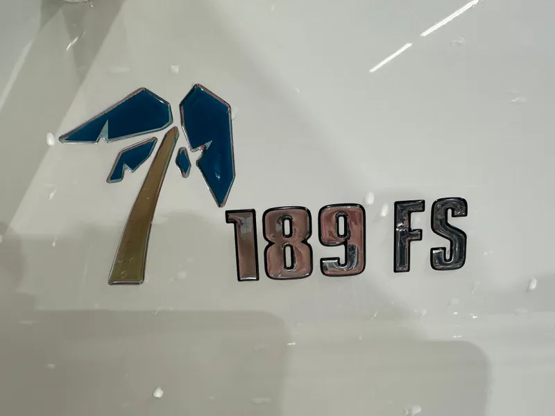 Slide: The Image of 2024 Key West 189FS logo on boat hull, featuring blue and gold design. - 22