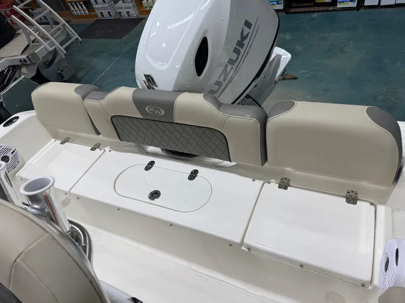 Slide: The Image of 2025 Key West 189FS boat interior with Suzuki engine, featuring cushioned seating and storage compartments. - 10