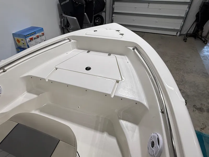 Slide: The Image of 2025 Key West 189FS boat interior with storage compartment and seating. - 14