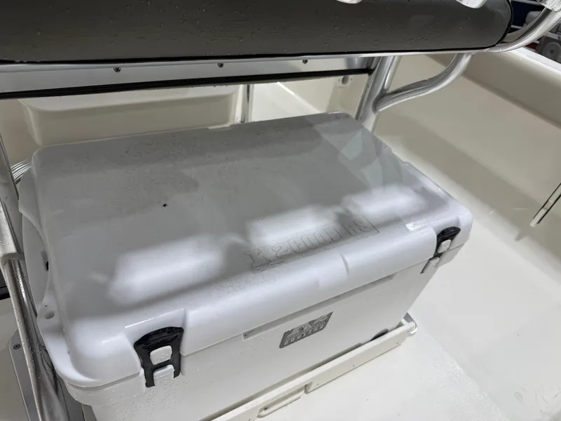 Slide: The Image of White cooler on 2025 Key West 189FS boat deck, secured with black latches. - 23