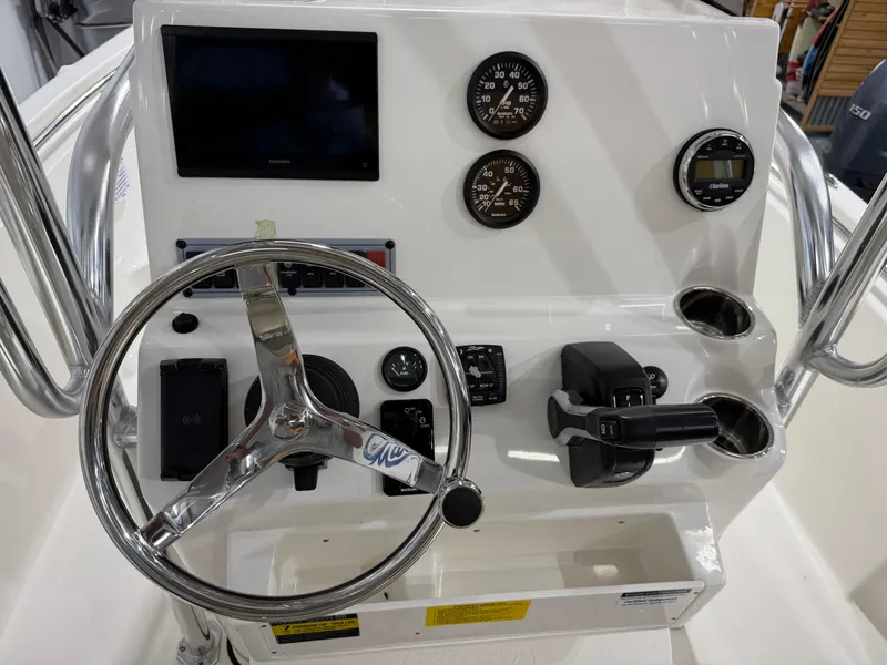 Slide: The Image of Key West 189FS 2025 boat dashboard with steering wheel and controls. - 25