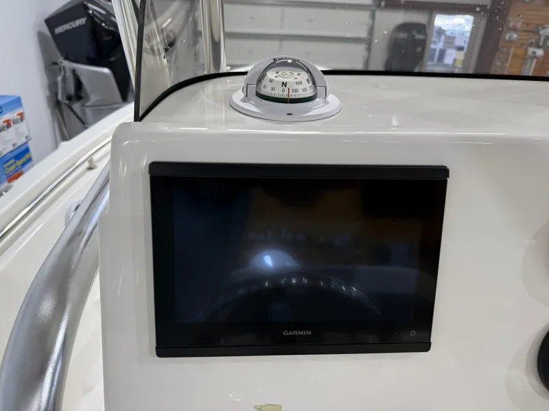 Slide: The Image of Garmin display and compass on 2025 Key West 189FS boat dashboard. - 26