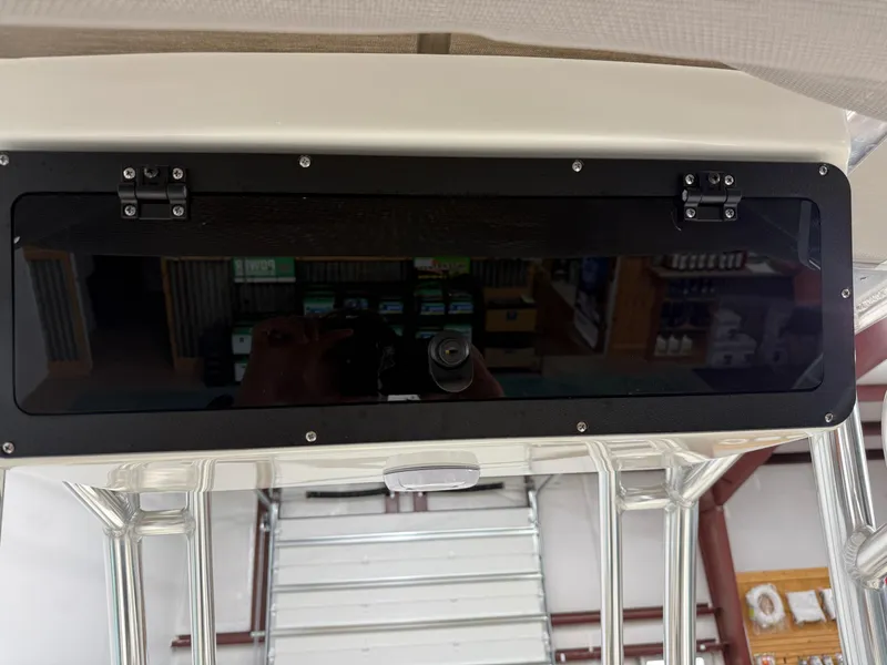 Slide: The Image of Key West 189FS 2025 boat console with storage compartment in a showroom. - 31