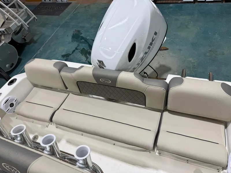 Slide: The Image of 2025 Key West 189FS boat interior with cushioned seating and Suzuki outboard motor. - 37