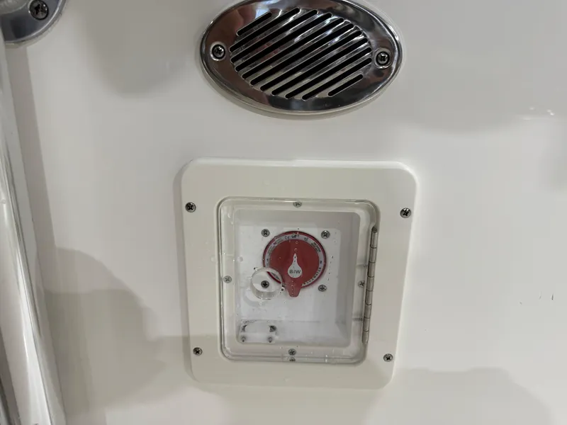 Slide: The Image of 2025 Key West 189FS boat battery switch and vent detail. - 38