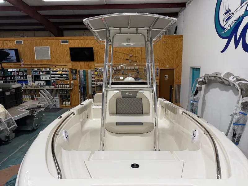 Slide: The Image of 2025 Key West 189FS boat interior in showroom, featuring seating and console. - 9