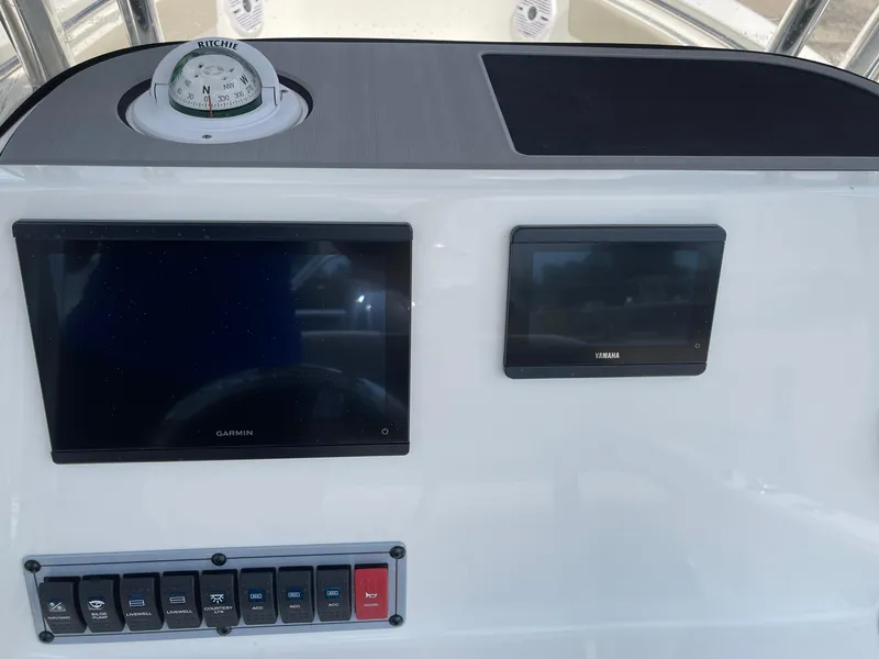 Slide: The Image of Key West 203FS 2025 boat dashboard with Garmin and Yamaha displays. - 12
