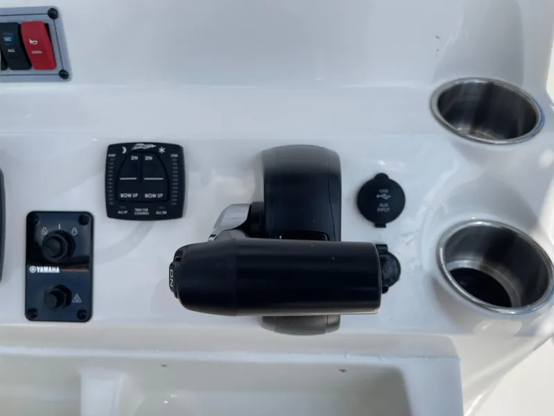 Slide: The Image of Key West 203FS 2025 boat control panel with Yamaha throttle and cup holders. - 13