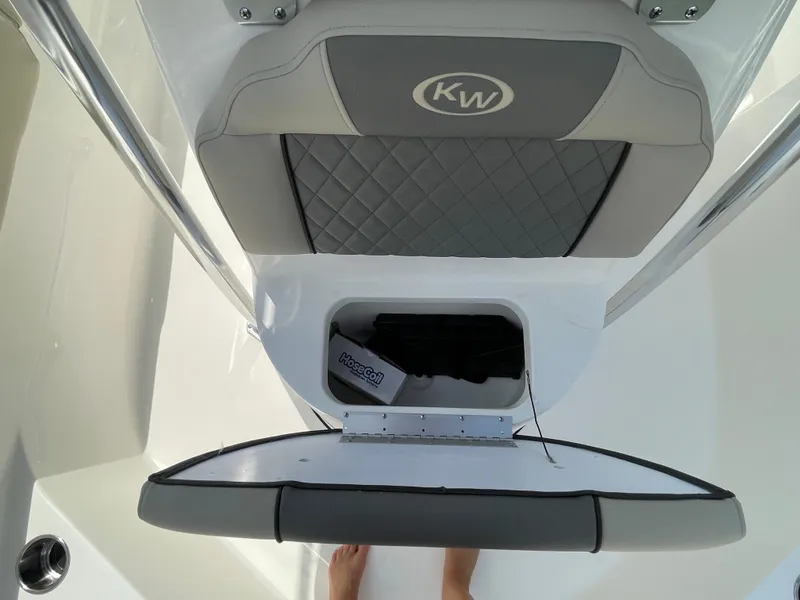 Slide: The Image of 2025 Key West 203FS boat seat storage compartment with HoseCoil accessory. - 14
