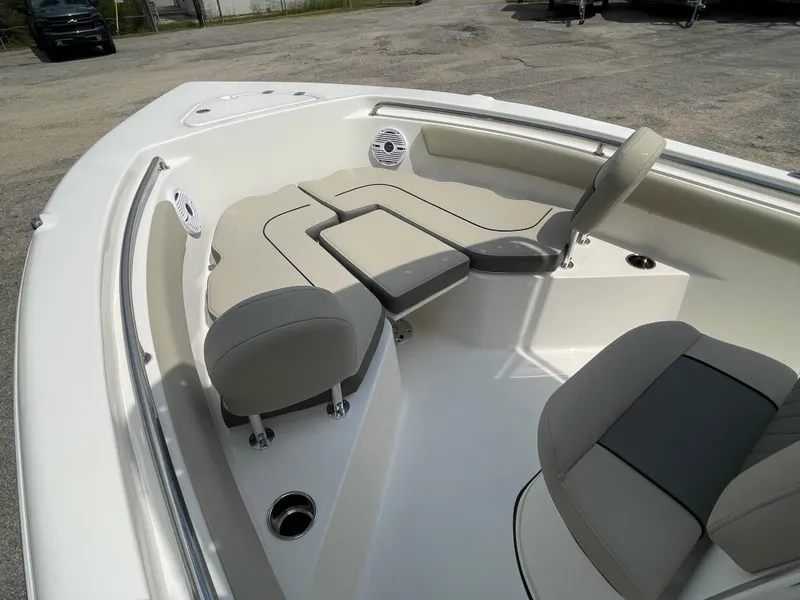Slide: The Image of 2025 Key West 203FS boat interior with cushioned seating and cup holders. - 17