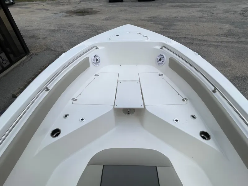 Slide: The Image of 2025 Key West 203FS boat interior with storage compartments and speakers. - 22