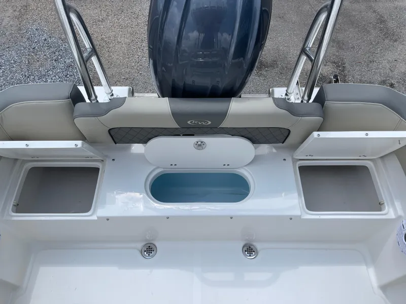 Slide: The Image of 2025 Key West 203FS boat interior with storage compartments and seating. - 24