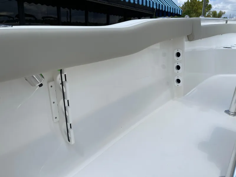 Slide: The Image of 2025 Key West 203FS boat interior detail with rod holders and clean white finish. - 26