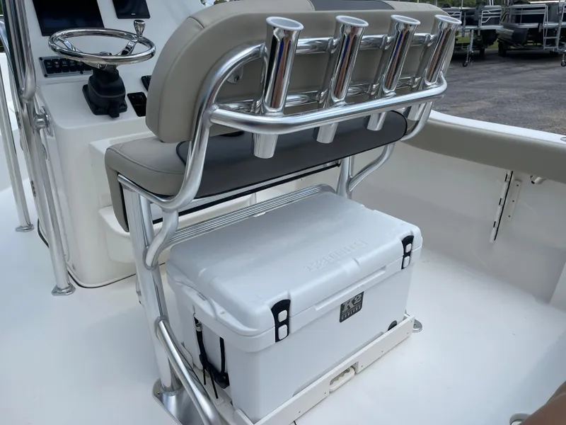 Slide: The Image of 2025 Key West 203FS boat interior with rod holders and cooler storage. - 29