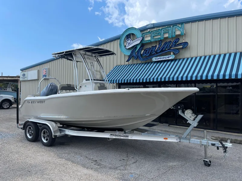 Slide: The Image of 2025 Key West 203FS boat on trailer outside Ocean Marine Group building. - 3