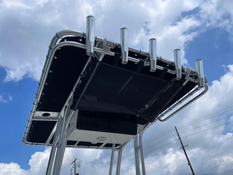 Slide: The Image of Key West 203FS 2025 boat T-top with rod holders against cloudy sky. - 30