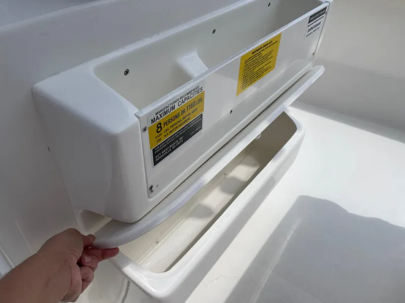Slide: The Image of Key West 203FS 2025 boat storage compartment with capacity label for 8 persons. - 32