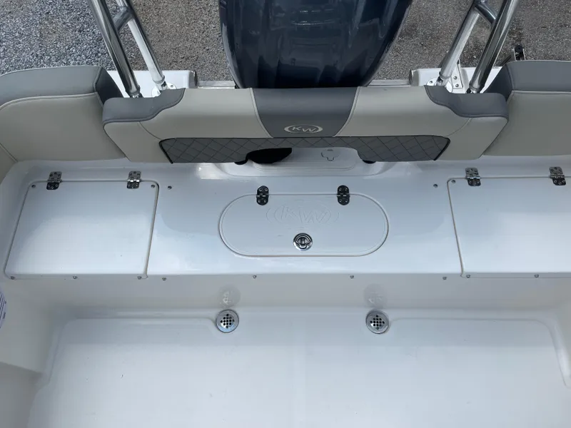 Slide: The Image of 2025 Key West 203FS boat interior with storage compartments and seating. - 34
