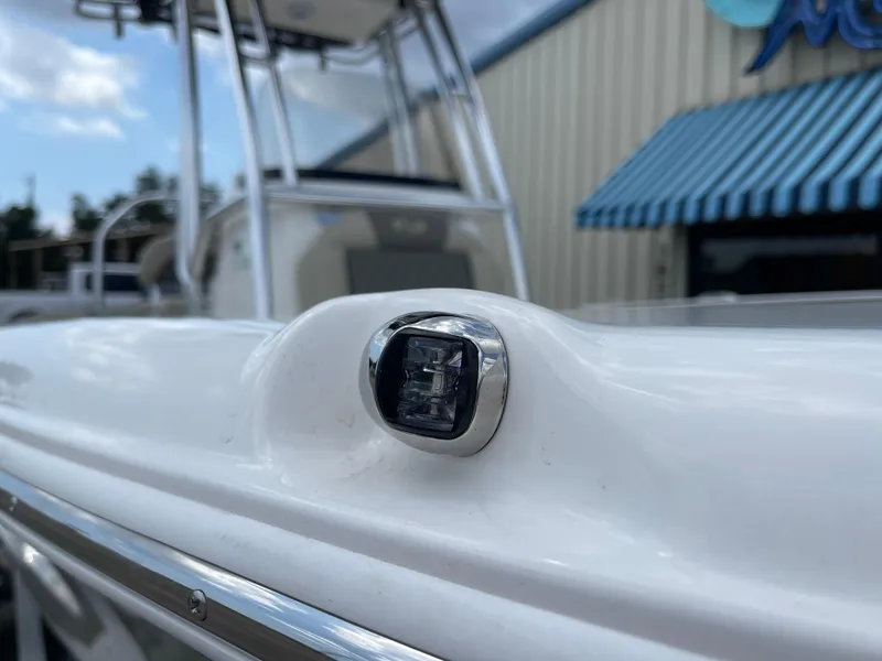 Slide: The Image of Close-up of 2025 Key West 203FS boat detail with blue awning in background. - 37
