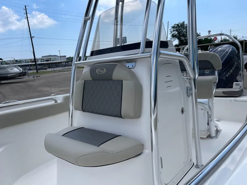 Slide: The Image of 2025 Key West 203FS boat interior with cushioned seating and console. - 7