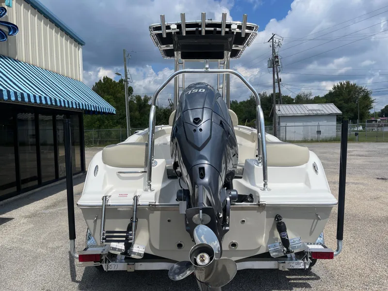 Slide: The Image of 2025 Key West 203FS boat with powerful outboard motor, parked outdoors. - 8