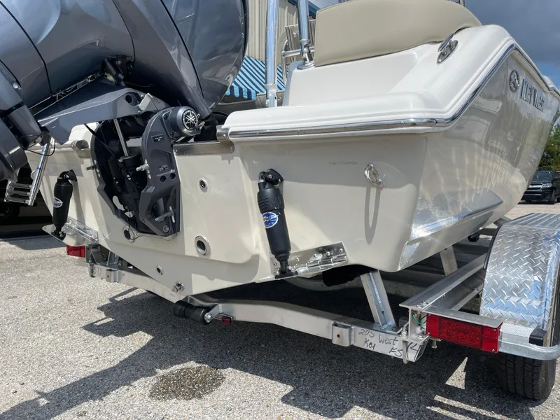 Slide: The Image of 2025 Key West 203FS boat on trailer, rear view, showcasing engine and hull design. - 9