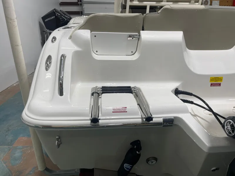 Slide: The Image of 2025 Key West 219fs boat stern with ladder and Mercury engine. - 10