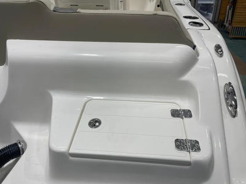 Slide: The Image of 2025 Key West 219fs boat interior with storage compartment and cup holders. - 12