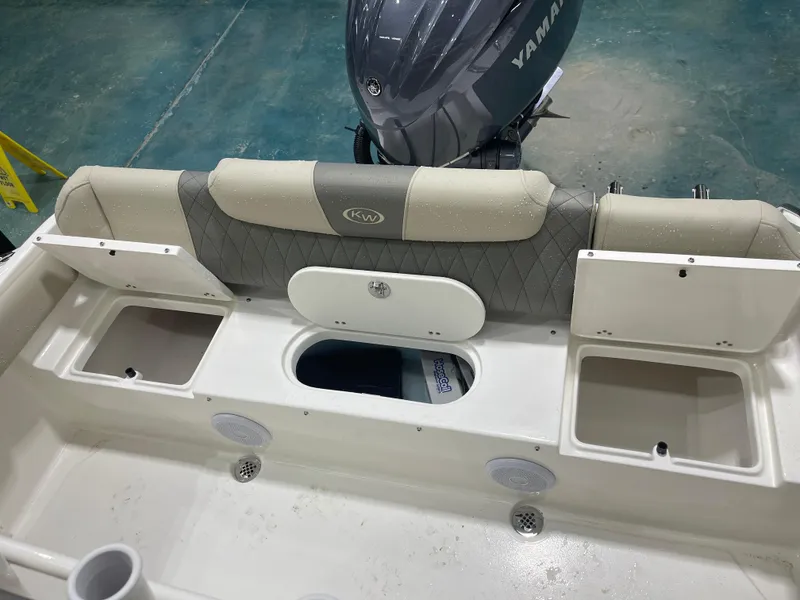 Slide: The Image of 2025 Key West 219fs boat interior with Yamaha engine, featuring storage compartments and seating. - 16