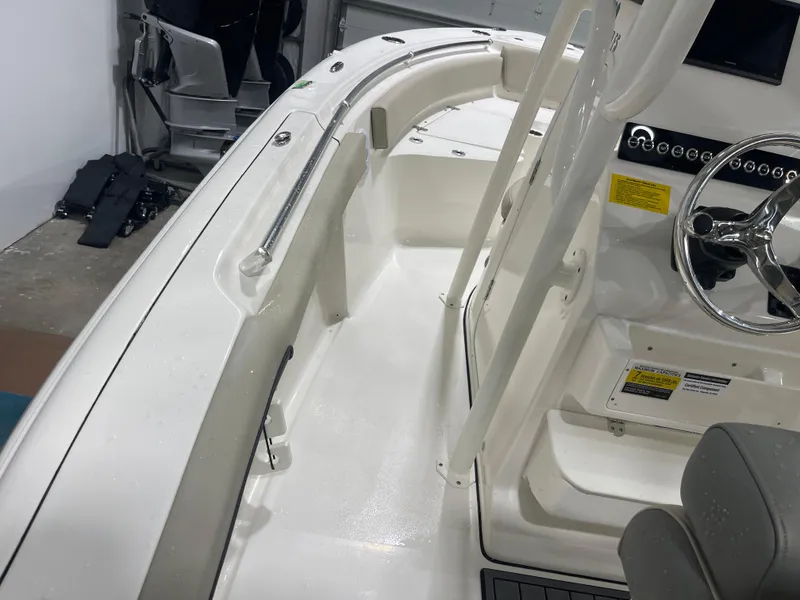 Slide: The Image of 2025 Key West 219fs boat interior with steering wheel and seating area. - 21