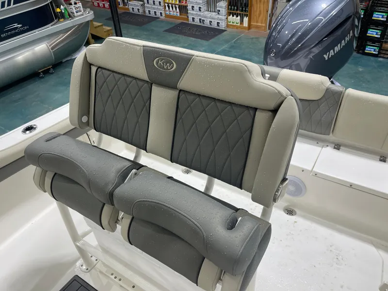 Slide: The Image of 2025 Key West 219fs boat interior with cushioned seating and Yamaha engine. - 23